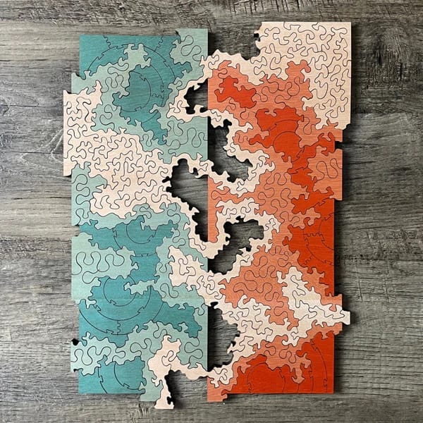 The finished "Cartographic Divide" jigsaw puzzle, with empty spaces on each side of a vertical line