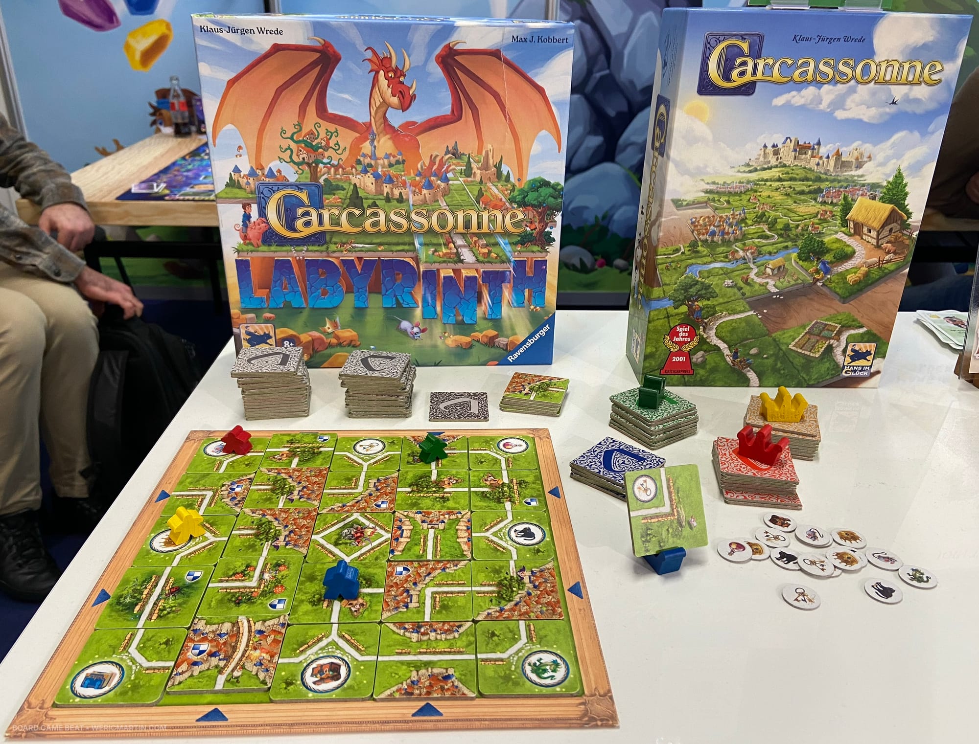 Front cover of Carcassonne: Labyrinth behind a display of the game components