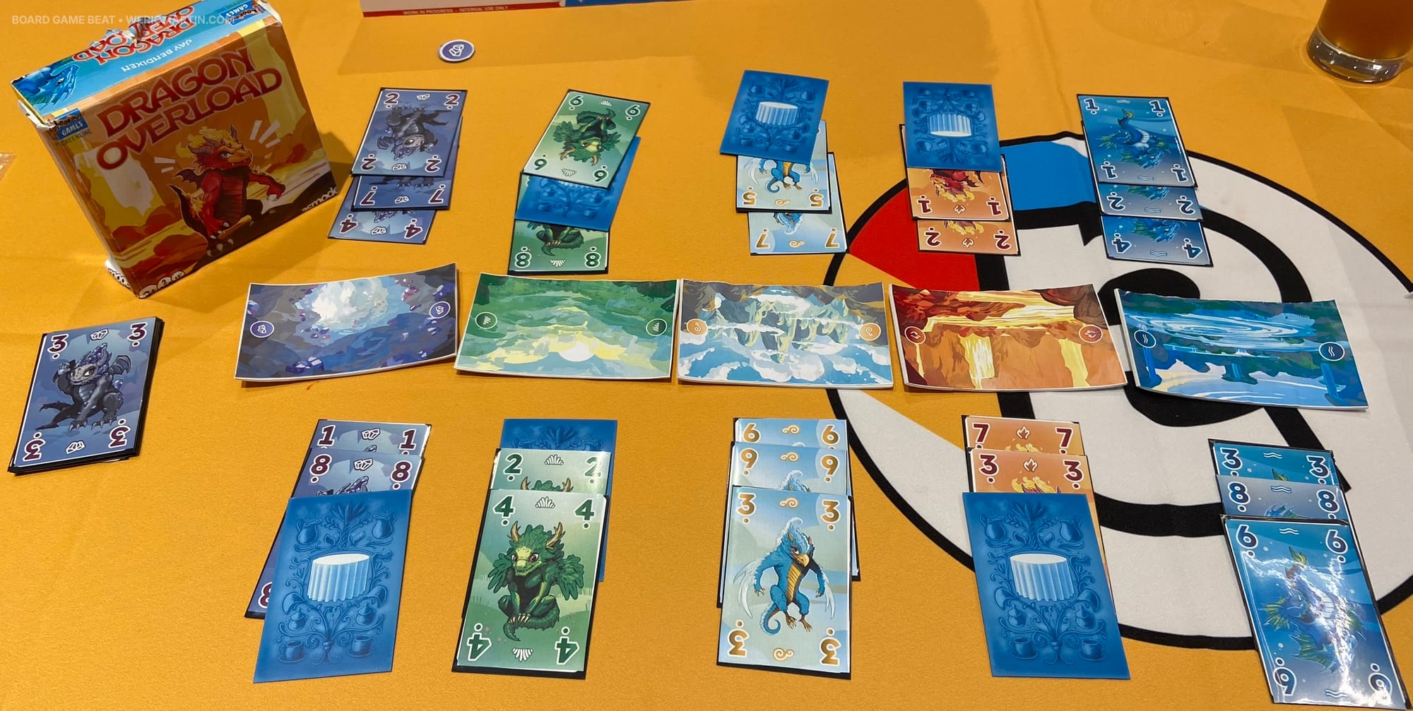 Five landscapes are fought over, with each player building a pile of three cards on each side of the landscape
