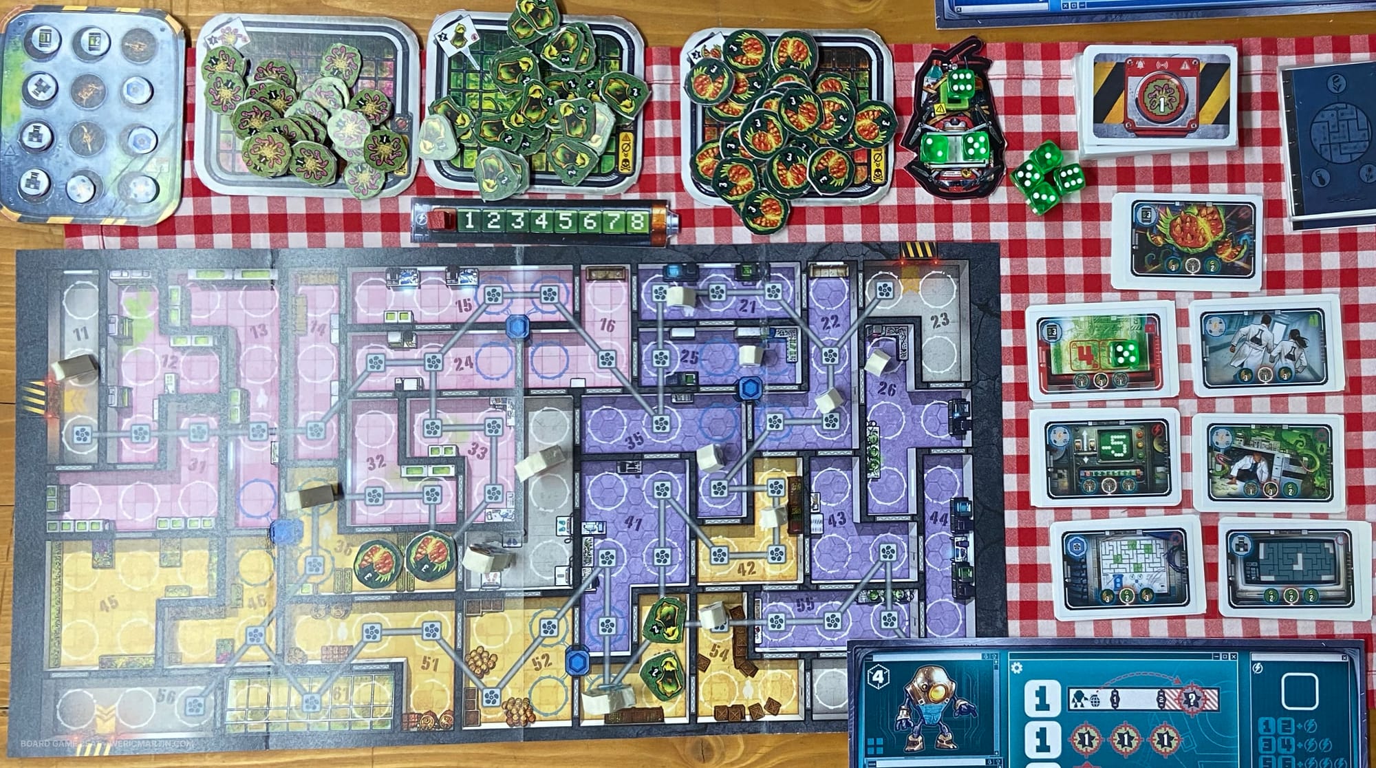 A game board showing connected room of various sizes, along with plant holding pens and objective cards