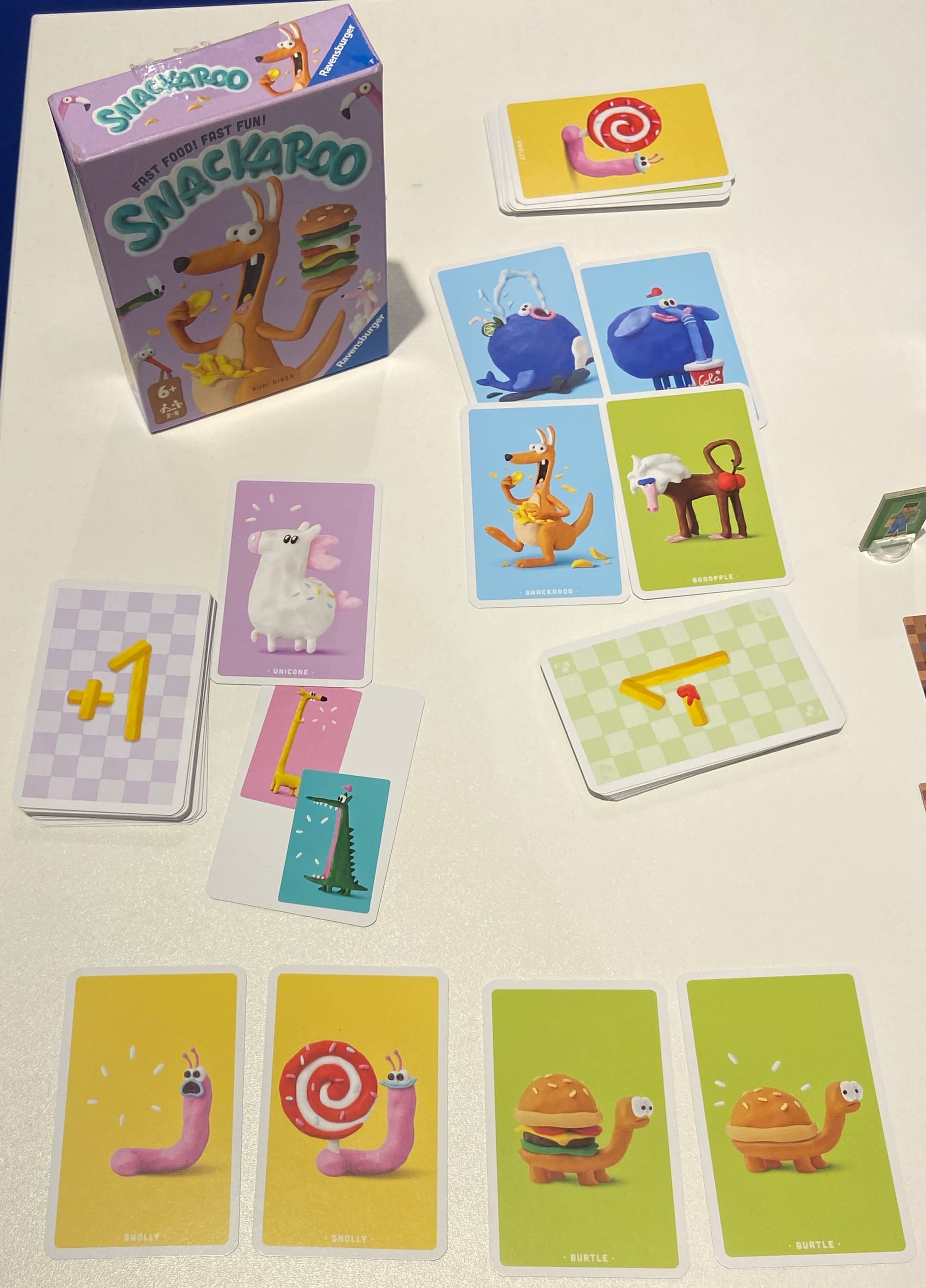 The box for Snackaroo, along with cards showing animals without and with snacks