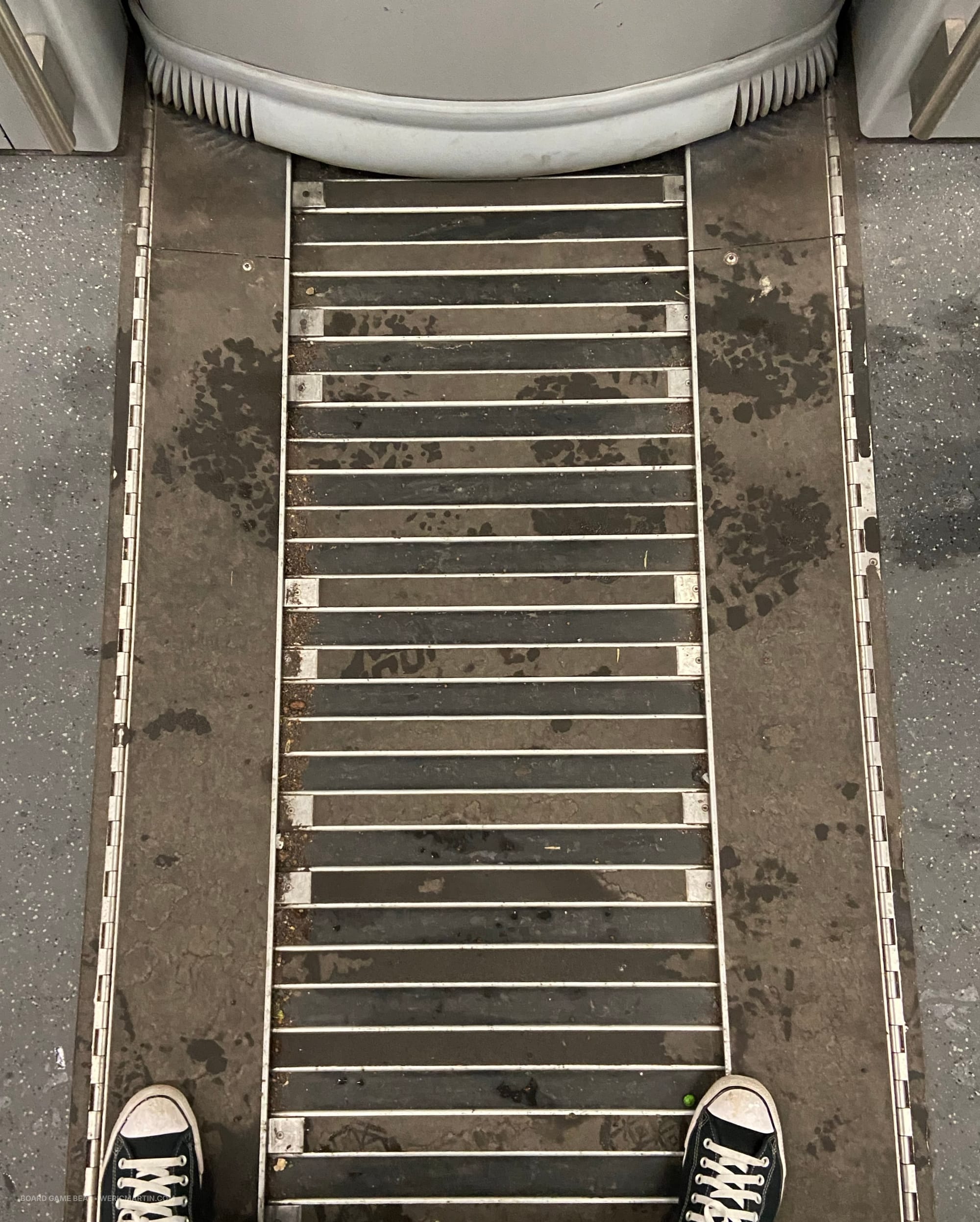 The grate that connects two subway cars, with the cars wiggling back and forth around corners
