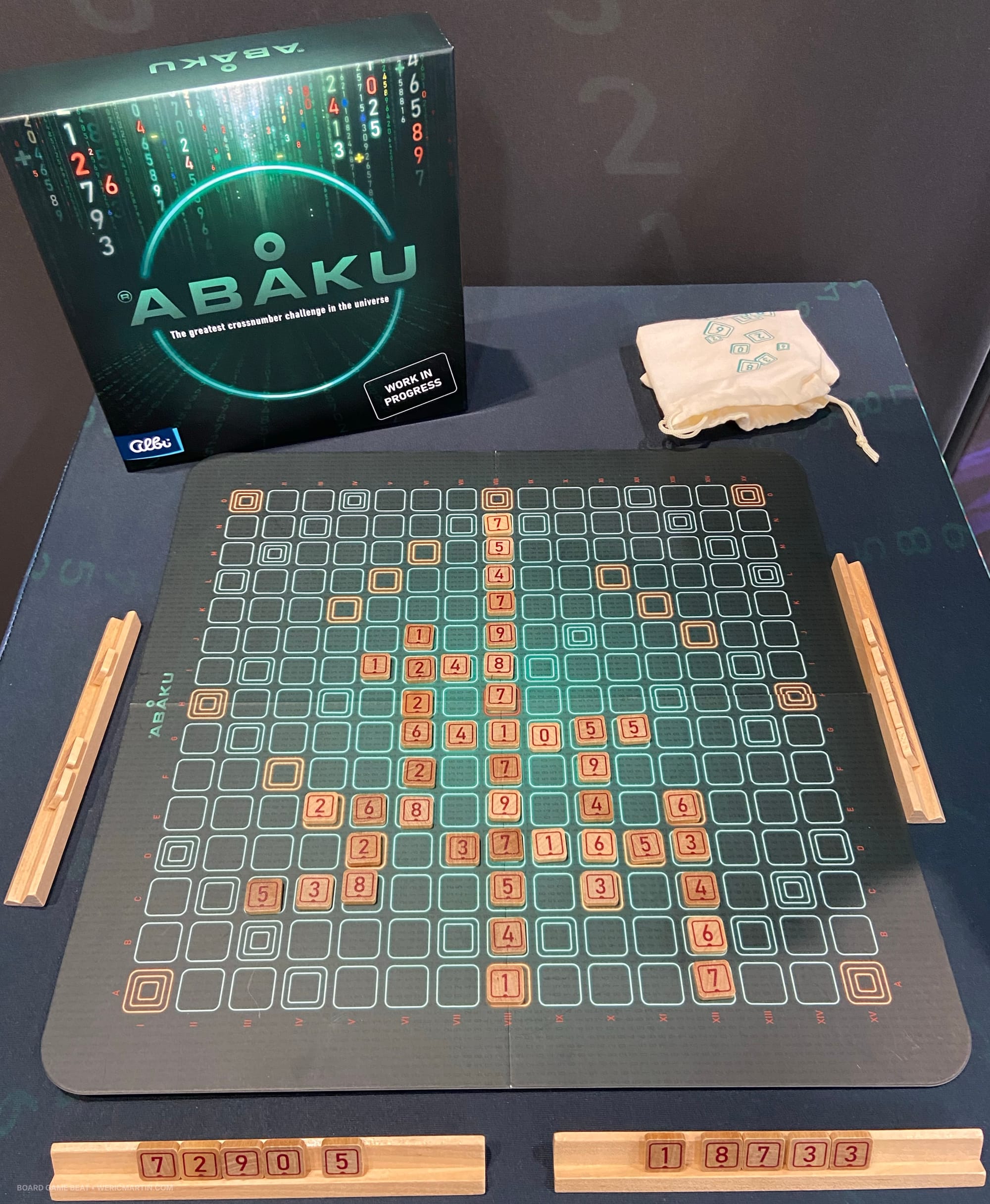 A grid of empty spaces on a game board with wooden tiles featuring numbers on many spaces