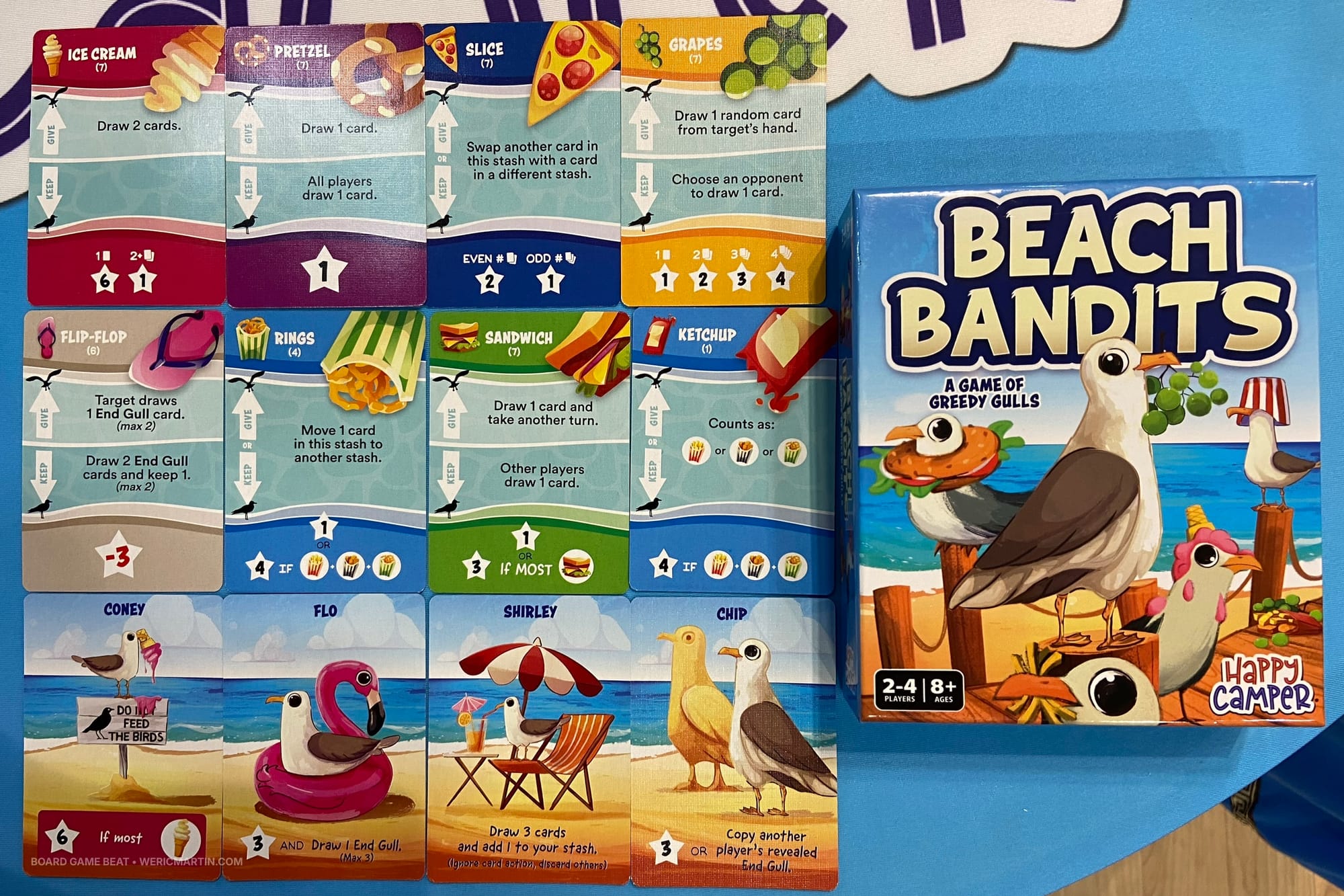 The game box for Beach Bandits, along with sample food cards and sample "End Gull" cards
