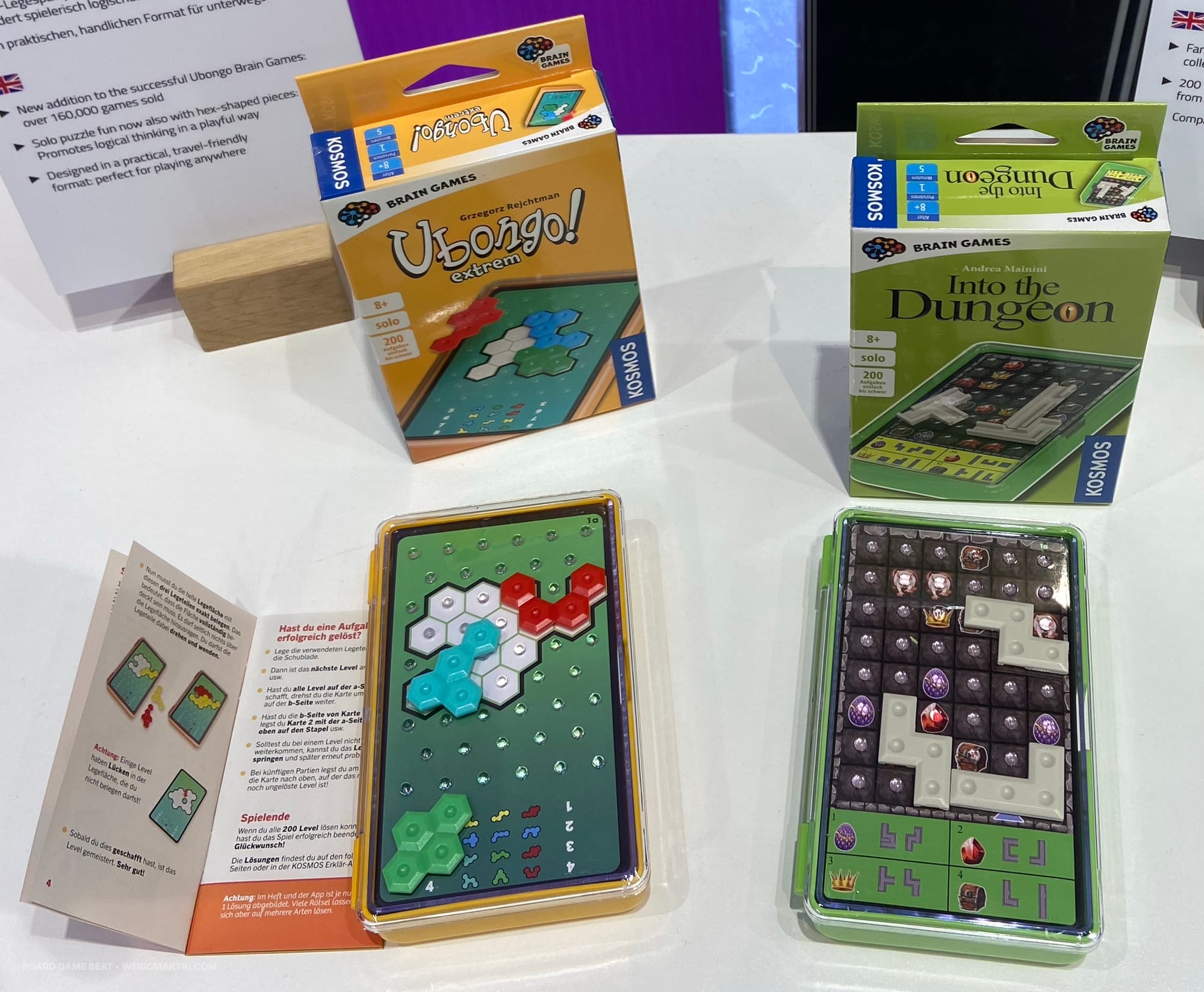 Two logic puzzles, each of which have you place plastic pieces on a grid: one to fill in a space, and the other to reach specific icons