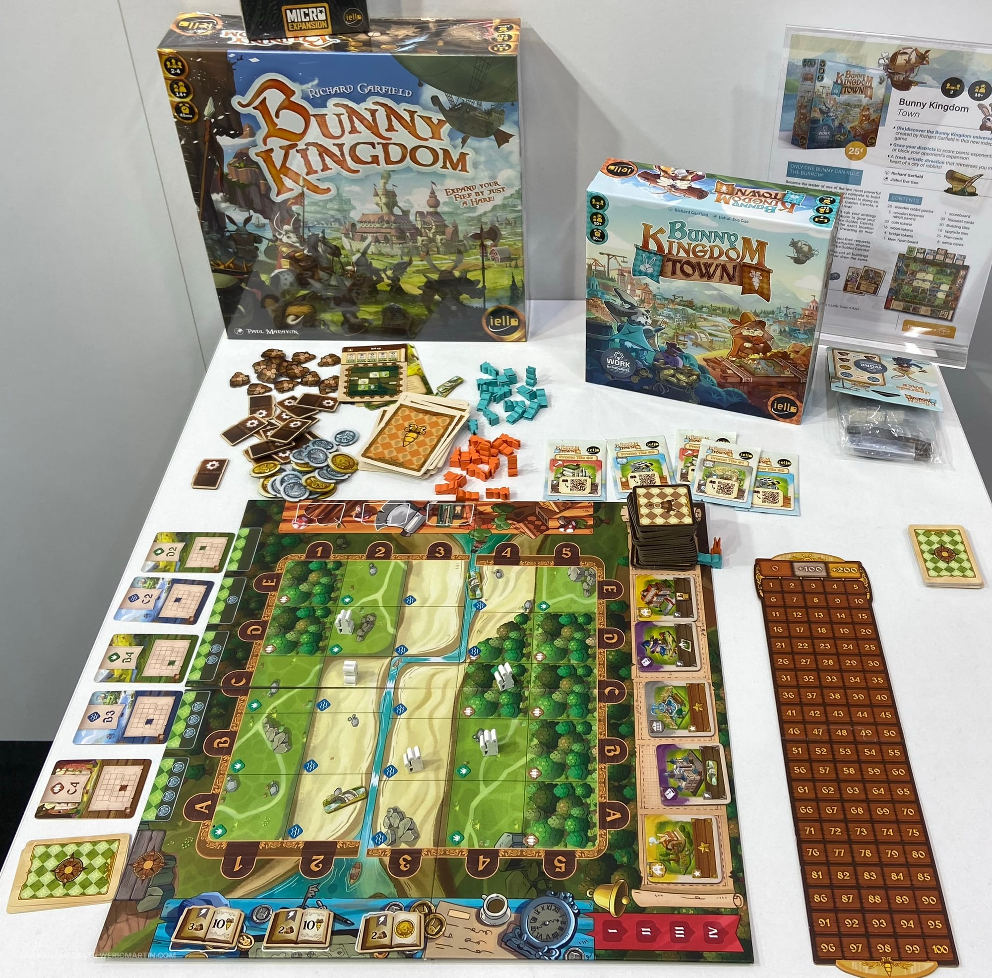 Boxes for Bunny Kingdom and Bunny Kingdom Town, with the components of the latter spread on the table