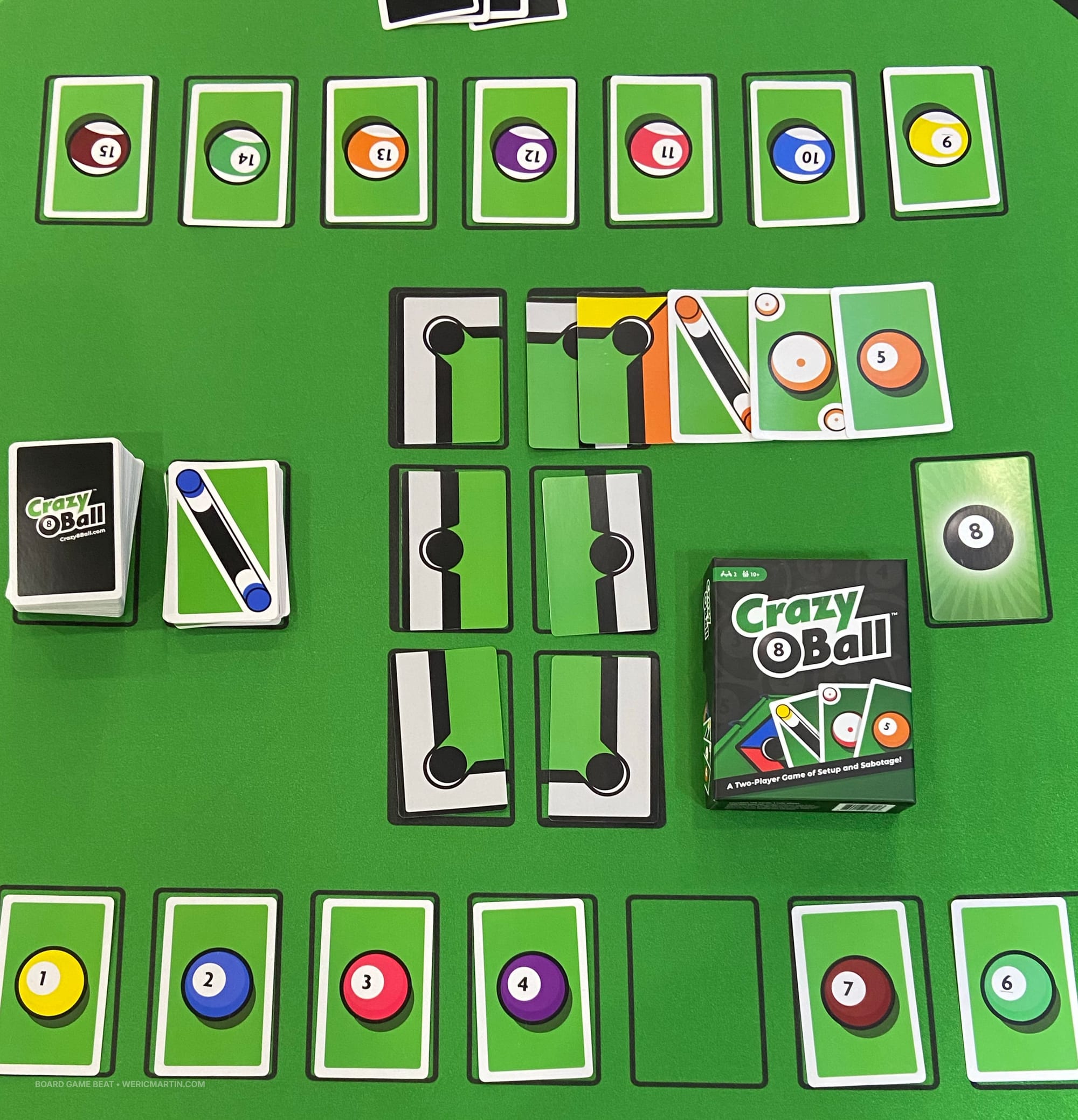 The game box for Crazy 8 Ball, with each player starting with seven colored balls and four cards in hand