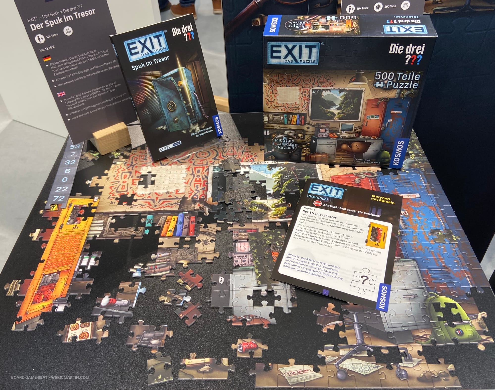 The box for EXIT: Das Puzzle – Die drei ???: Toteninsel is on top of a partially completed jigsaw puzzle