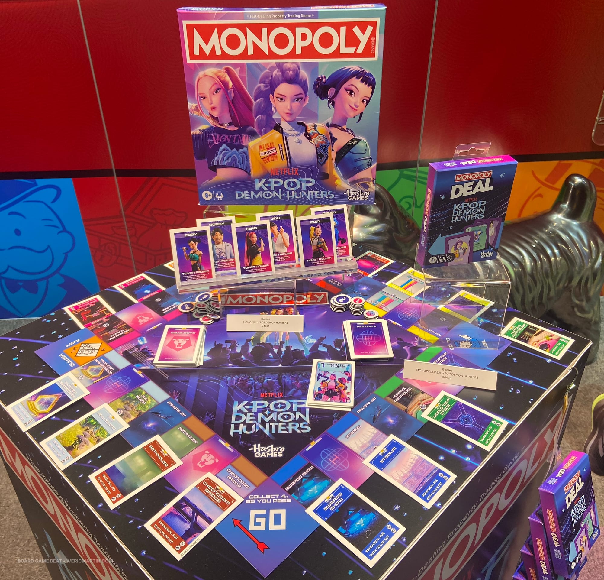 Pictured are Monopoly Deal: KPop Demon Hunters and Monopoly: KPop Demon Hunters, with the latter having its components on display