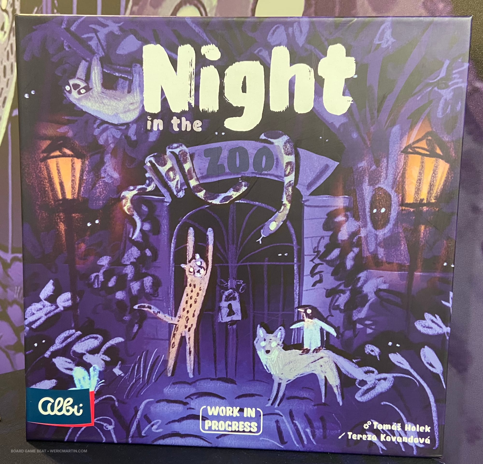 Front cover of Night in the Zoo, which shows animals trying to get through a closed gate