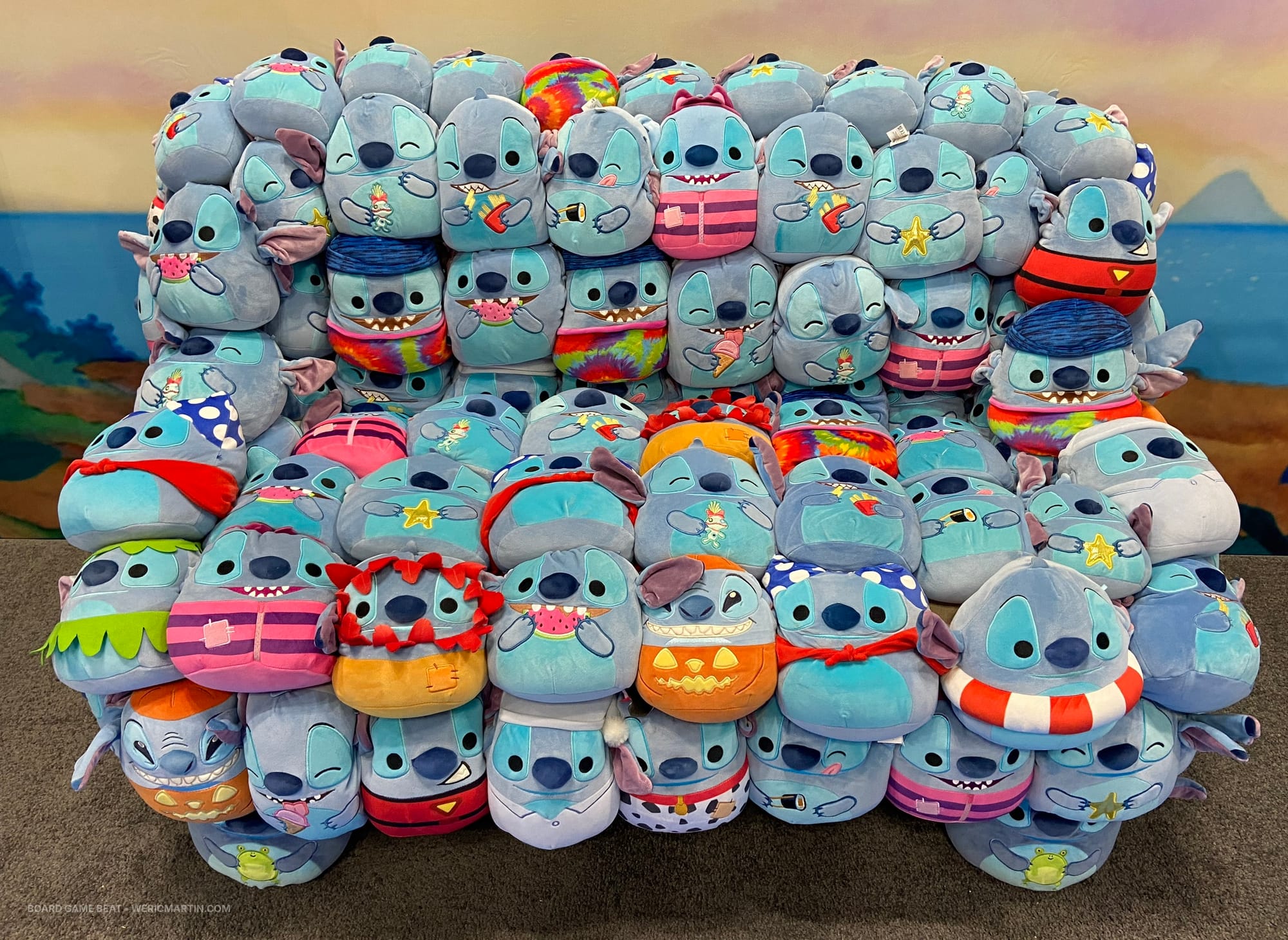 Approximately four dozen Stitch Squishmallows are stitched together in the shape of a love seat