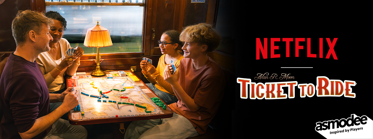 Four people sit at a table playing Ticket to Ride in what appears to be a train car, oblivious to the landscape whooshing past