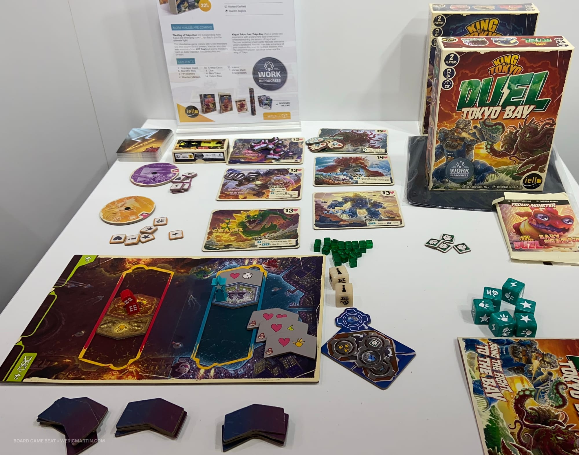 Non-final game components, including a game board with two "movement troughs", six monster tiles, a deck of power cards, dice, and more