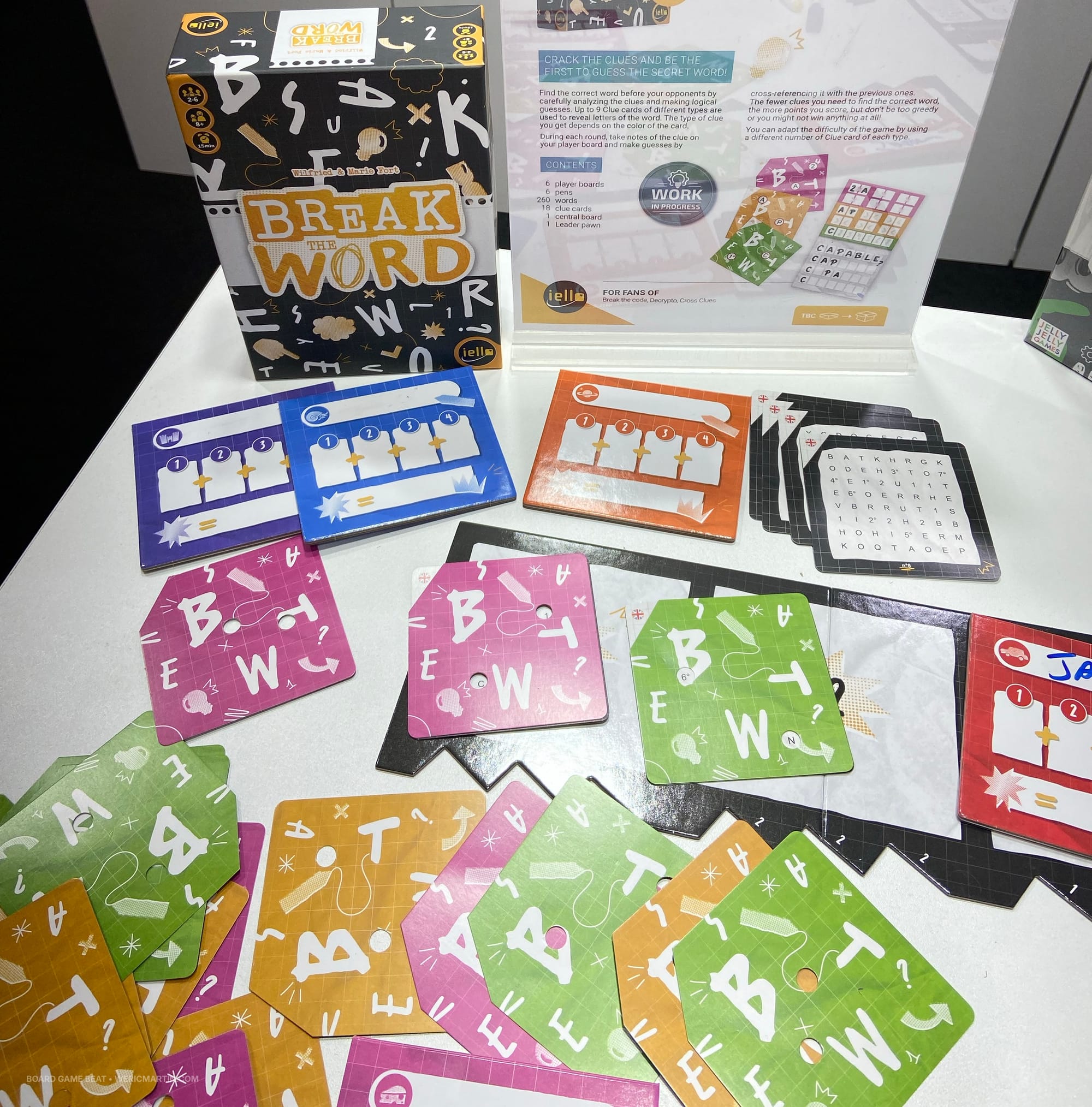 The Break the Word game box and square cards with holes in them that you overlay on a character grid to reveal only two characters